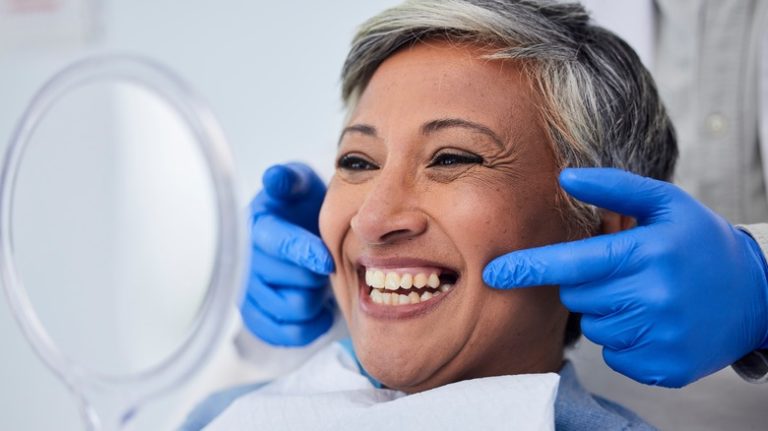 Top Foods to Eat After Your Dentist Appointment for a Healthy Diet Older woman smiling after teeth cleaning