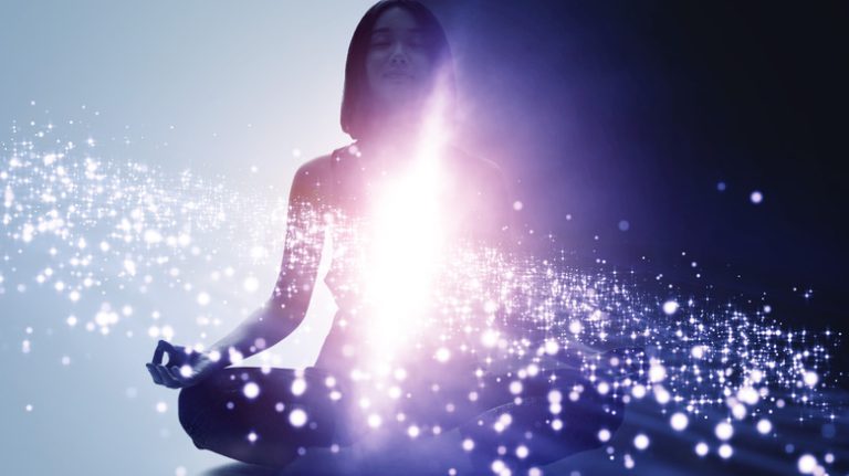 Exploring the Benefits of Imagery Techniques: A Comprehensive Guide a woman meditating and surrounded by stars and light