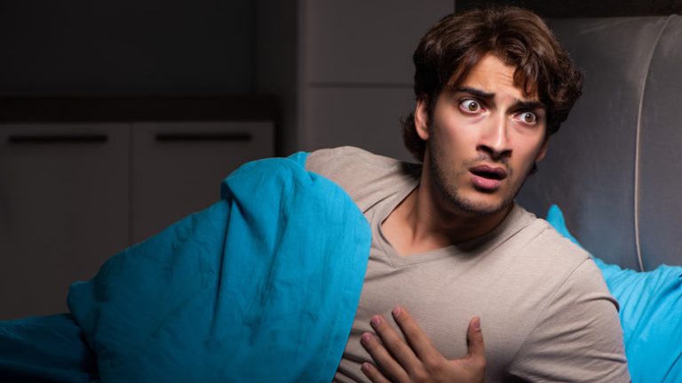 Is it Possible to Experience a Panic Attack While Sleeping? Man having nocturnal panic attack