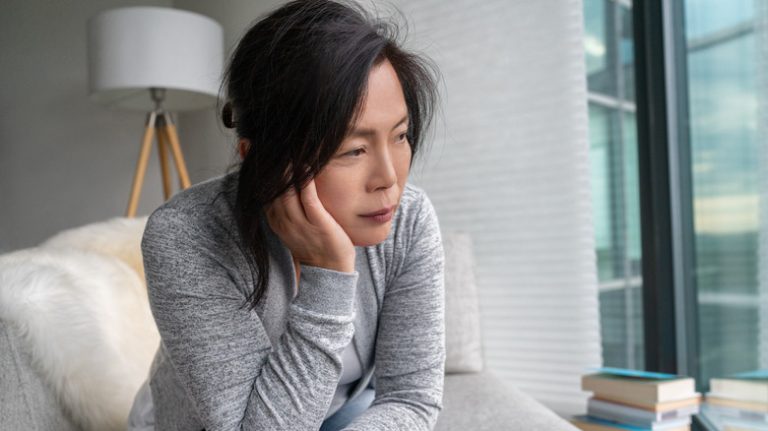 The Key Distinction Between Depression and Anxiety A sad woman leaning her head on her hand