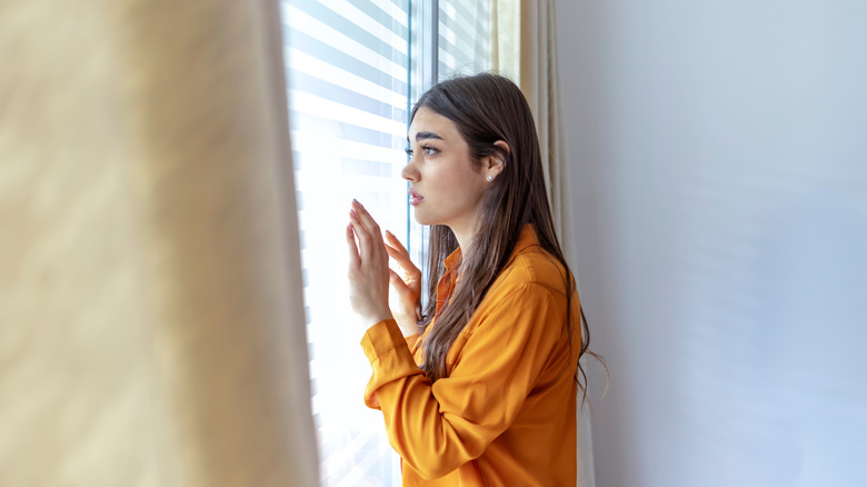 woman looking out window