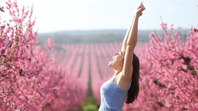 What is Spring Fever and is it Real? woman in field of pink flowers